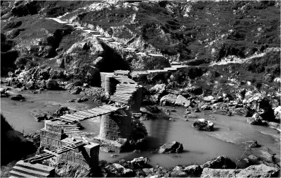 #001-109 For the first thirty years of the PRC, infrastructure investment did not extend to the deep countryside. Bridges were often in dangerous disrepair until after 1979.