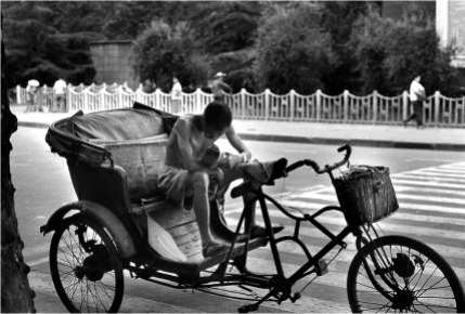 #110-041 By the 1930s, the pedicab replaced the hand-pulled rickshaw. As China modernized, the motor taxis have pretty much swept away them away. However, some still remain, sometimes with a battery-powered electric motor.
